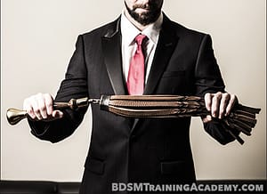 Master Bishop Holding Flogger